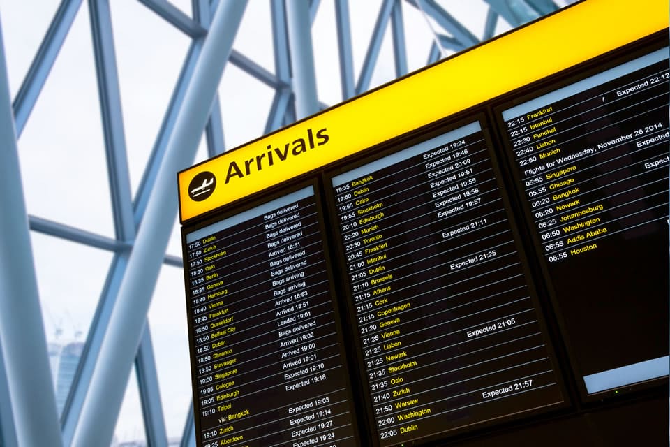 Image of an airport arrivals board.